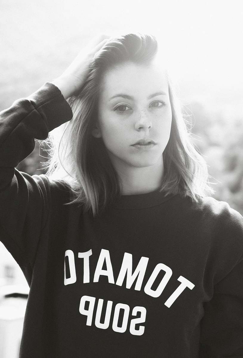 people grayscale photo of woman wearing sweatshirt holding her hair human