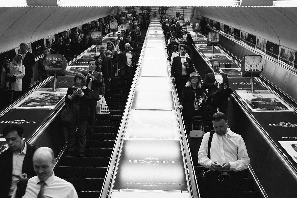 human grayscale photograph of people inside structure person
