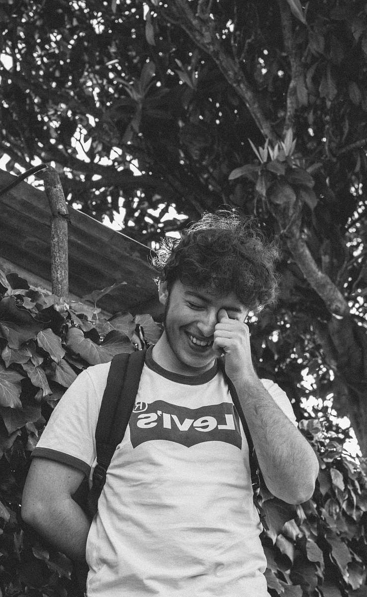face grayscale photography man standing outdoors human