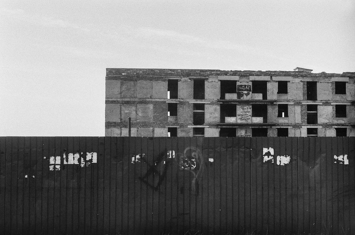 grey grayscale photography of abandoned building shipping container