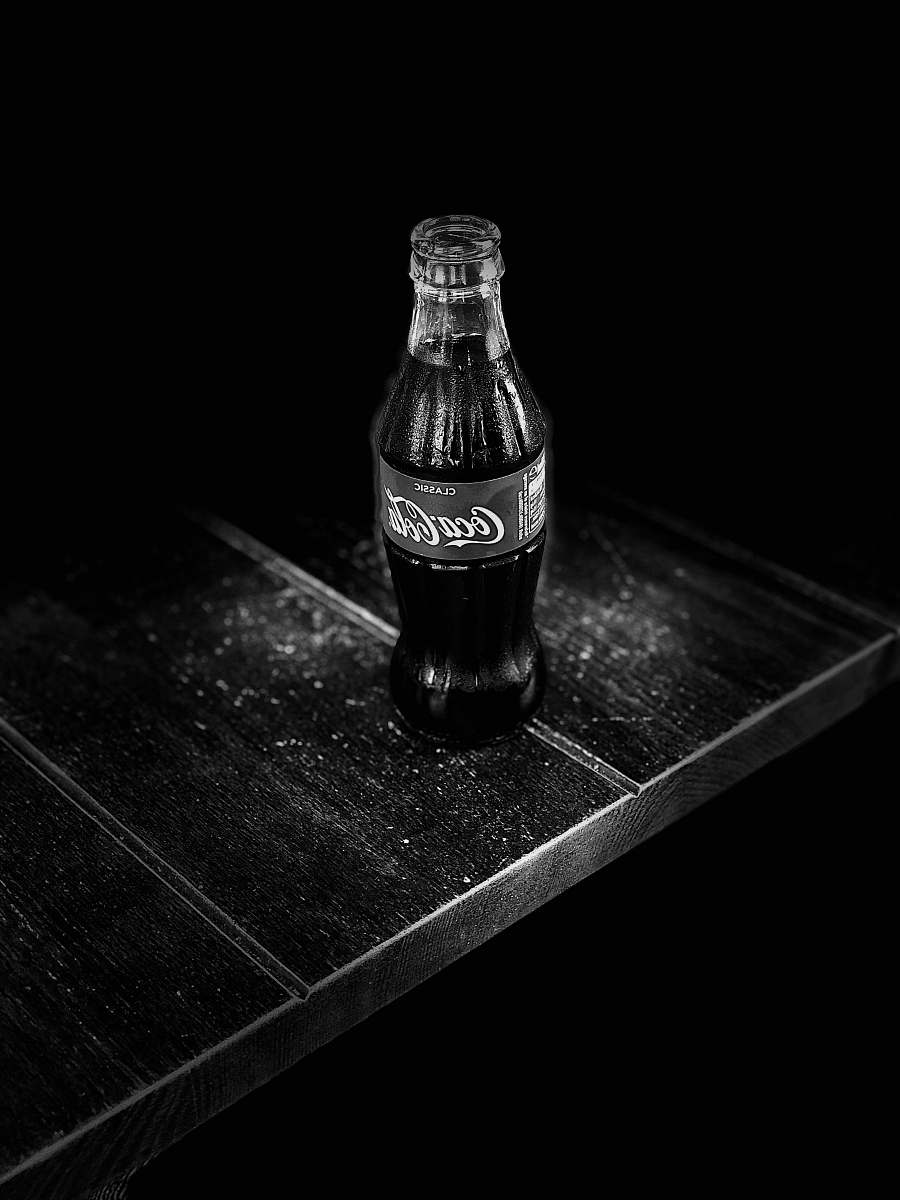 drink grayscale photography of Coca-Cola bottle on table coke