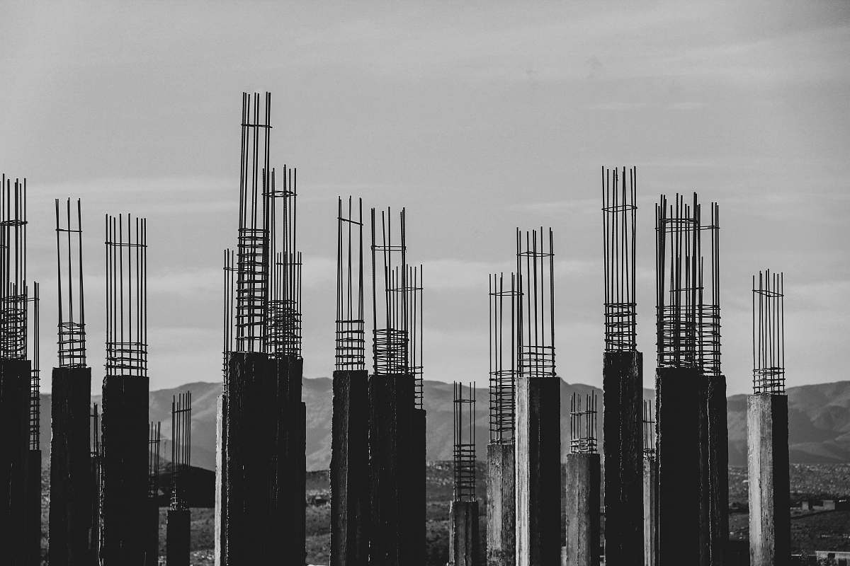grey grayscale photography of concrete posts construction