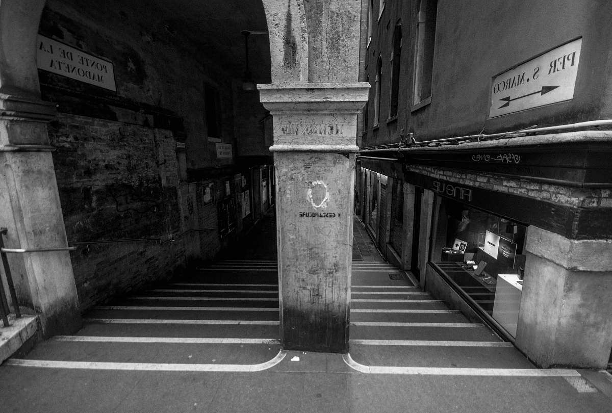 building grayscale photography of empty hallway banister