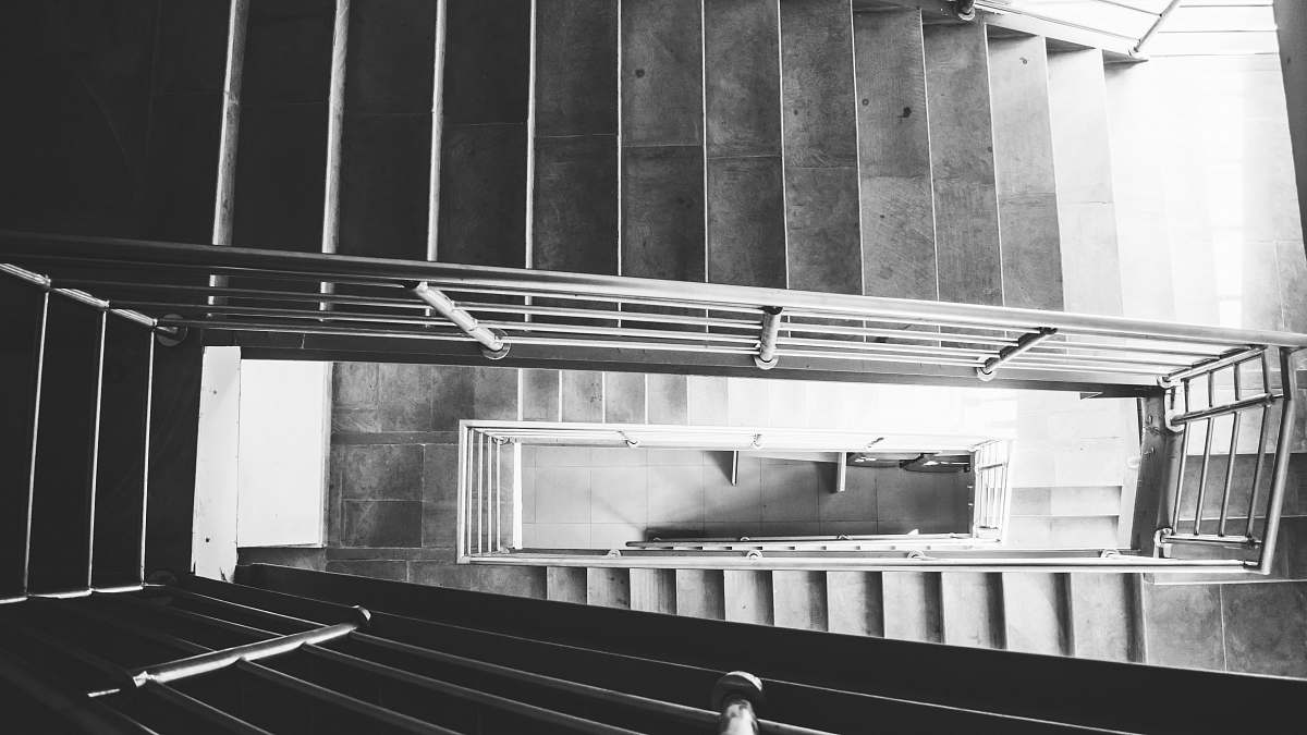 banister grayscale photography of empty staircase handrail