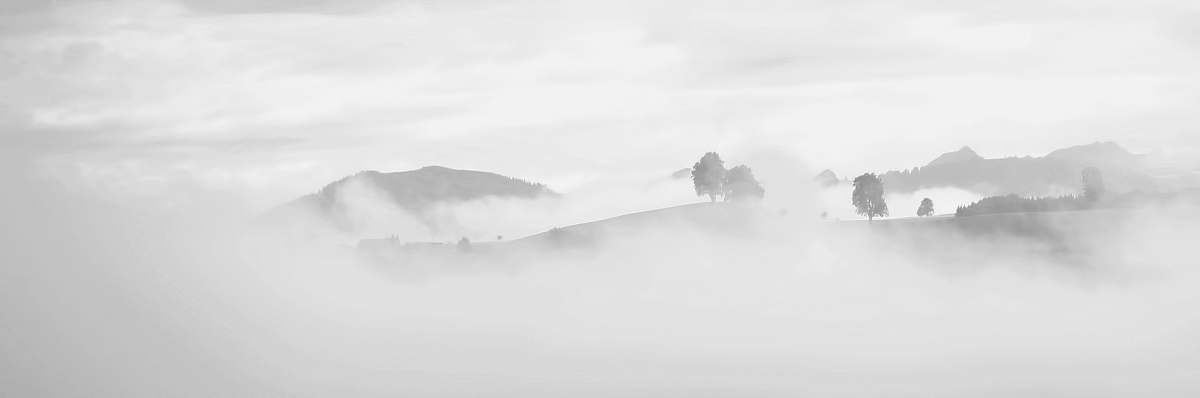 alps grayscale photography of foggy mountain mountain