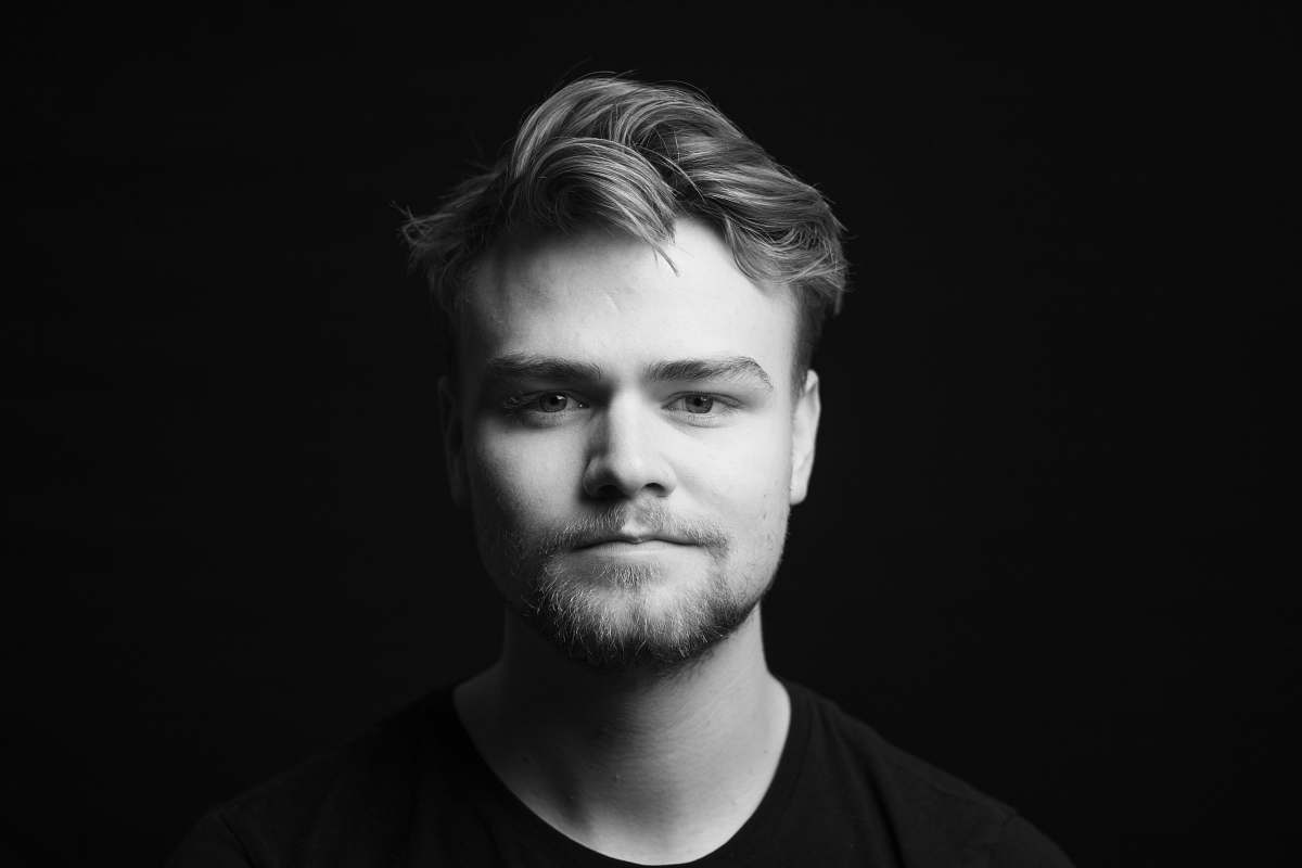face grayscale photography of man in crew-neck shirt person
