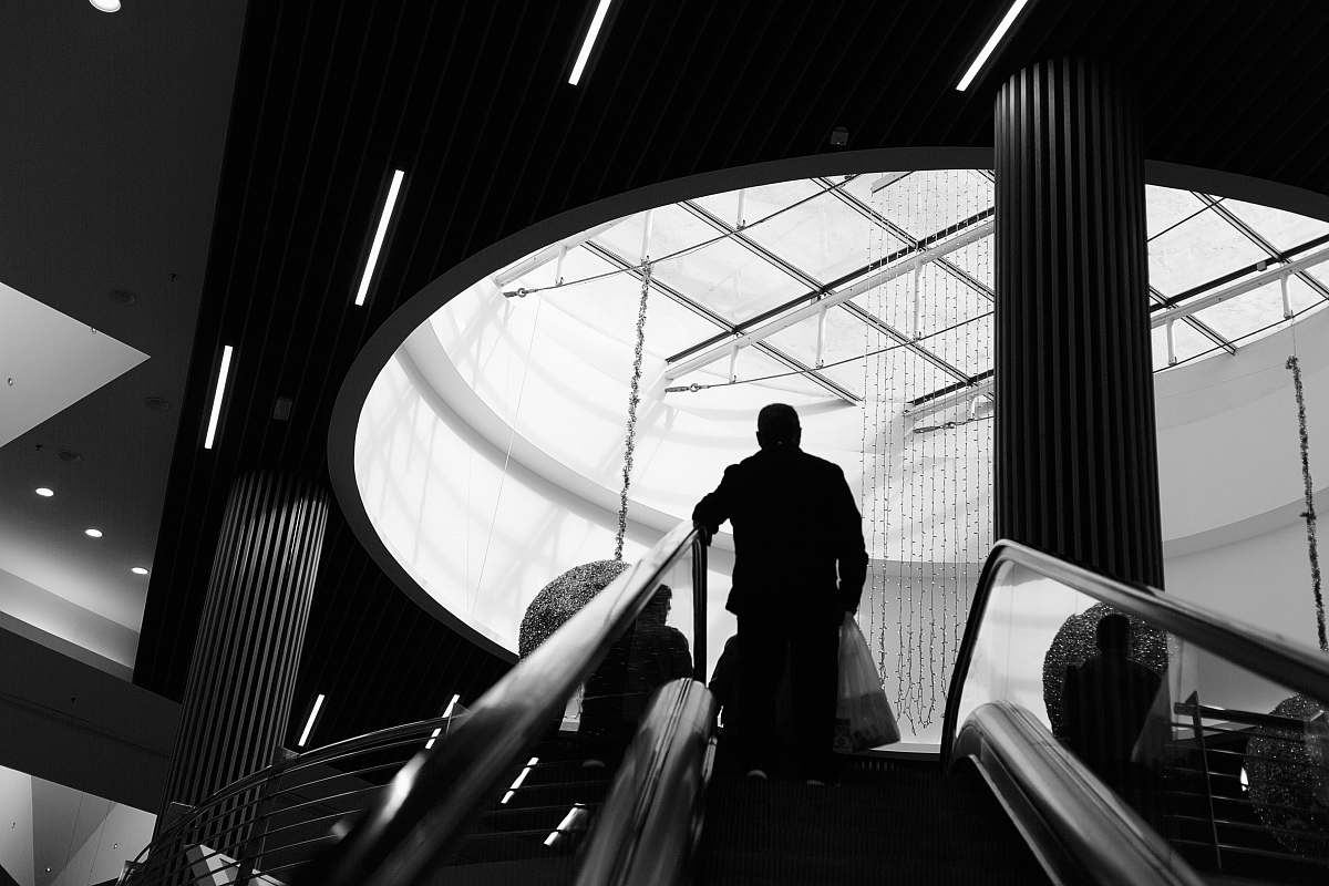 banister grayscale photography of man on stairs handrail