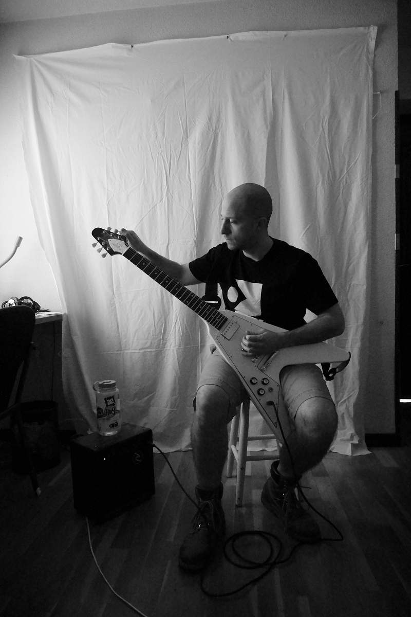 guitar grayscale photography of man sitting while playing electric guitar leisure activities