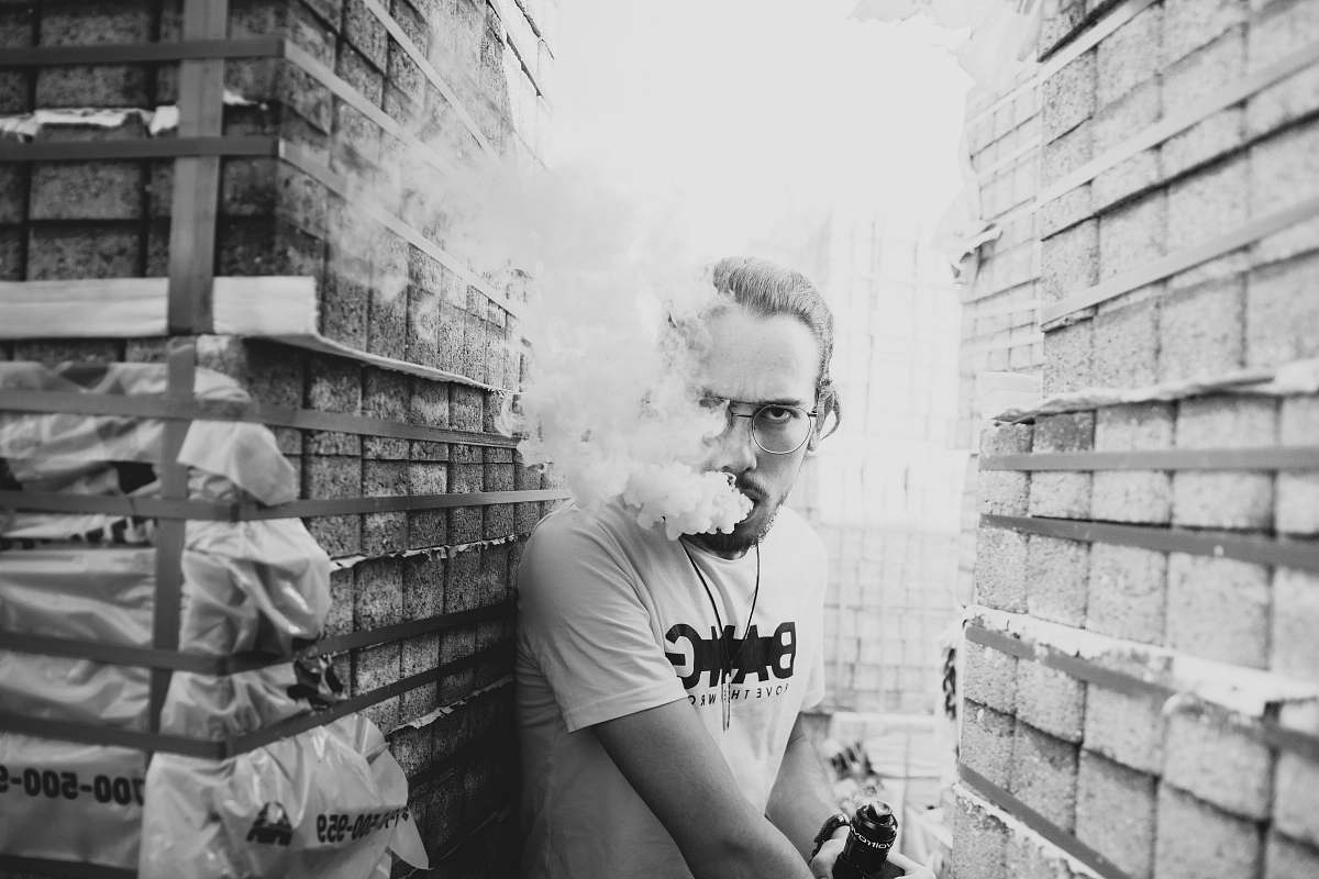 human grayscale photography of man smoking person
