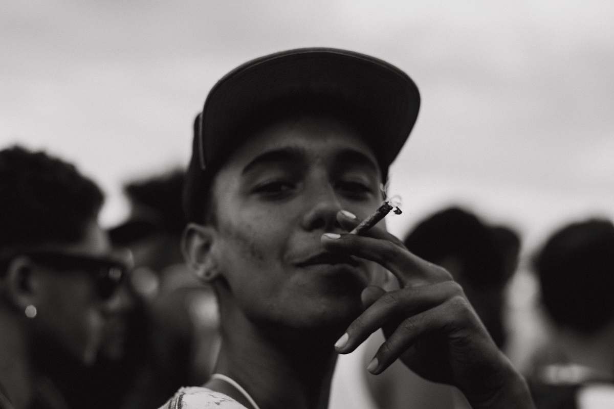 people grayscale photography of man smoking human