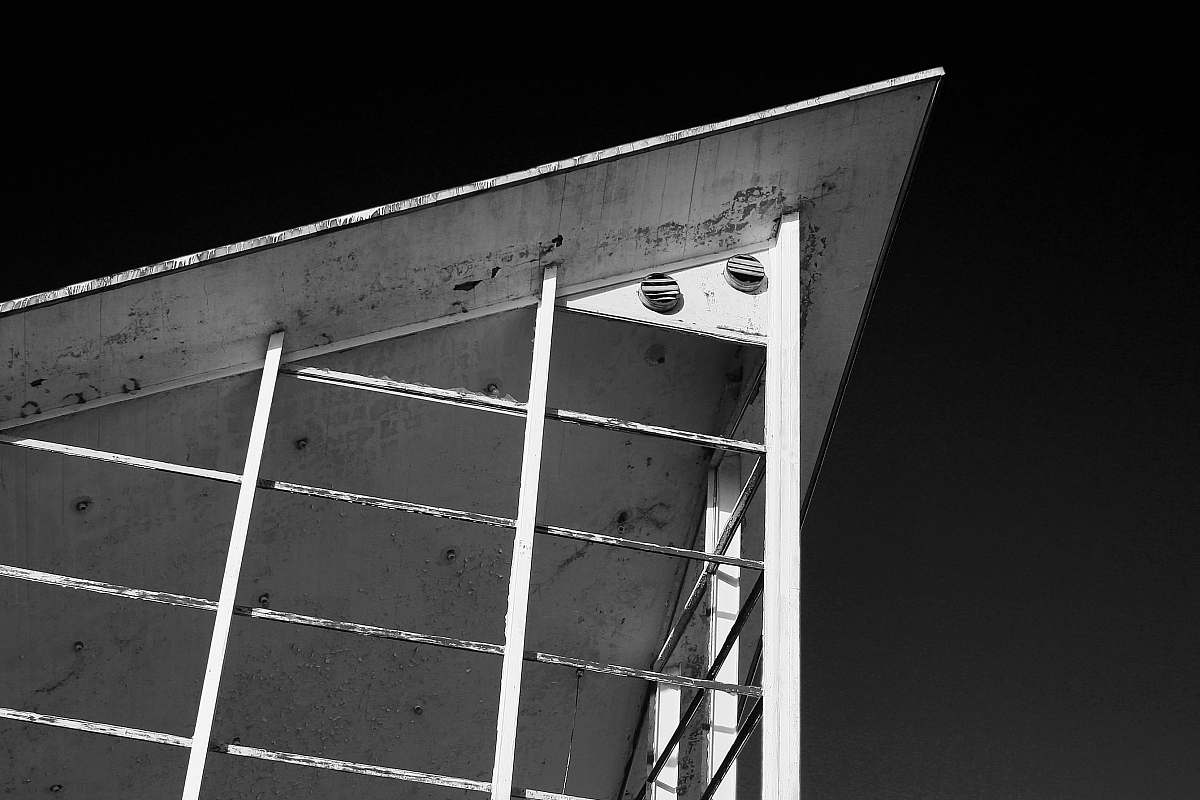 grey grayscale photography of metal arch roofg architecture