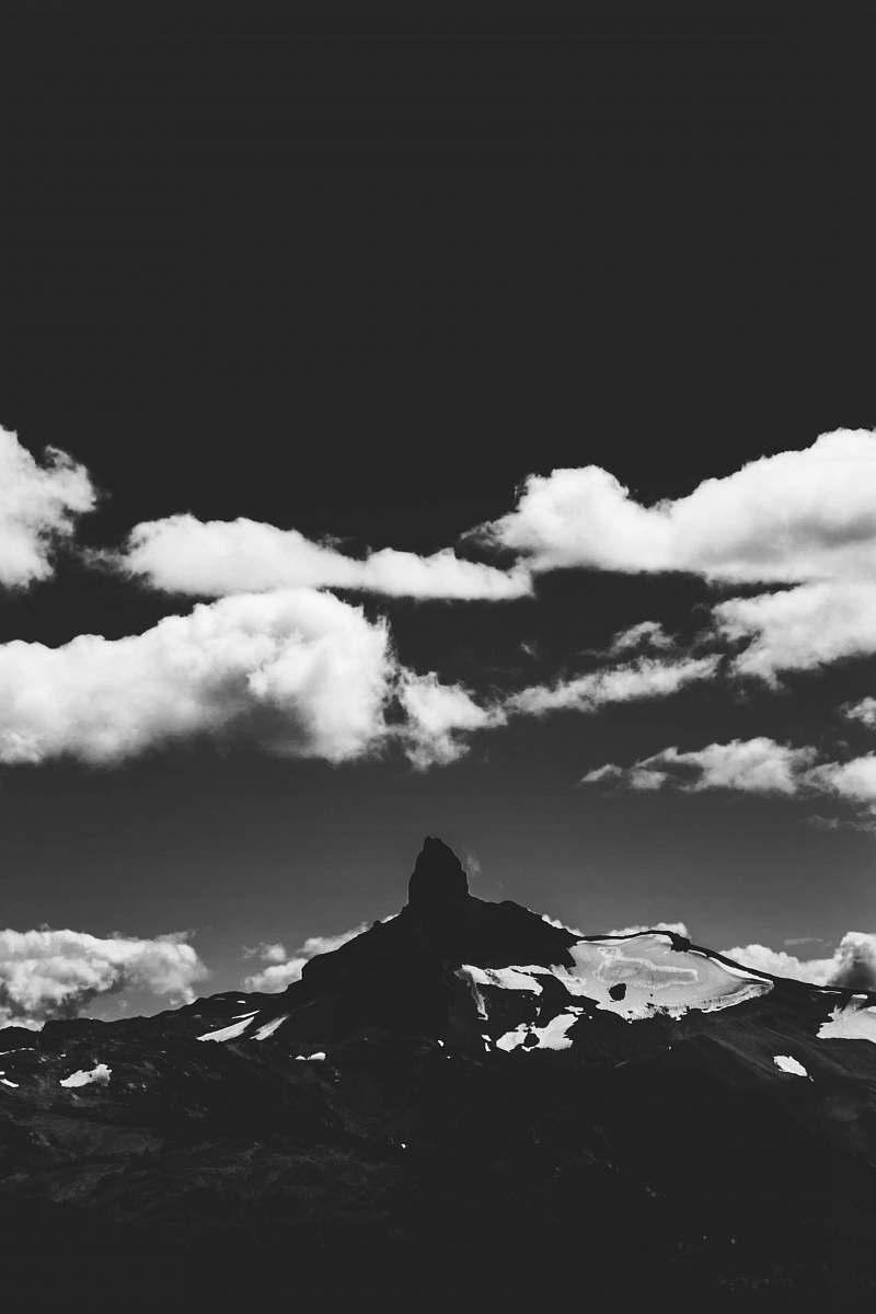 mountain grayscale photography of mountain and clouds nature
