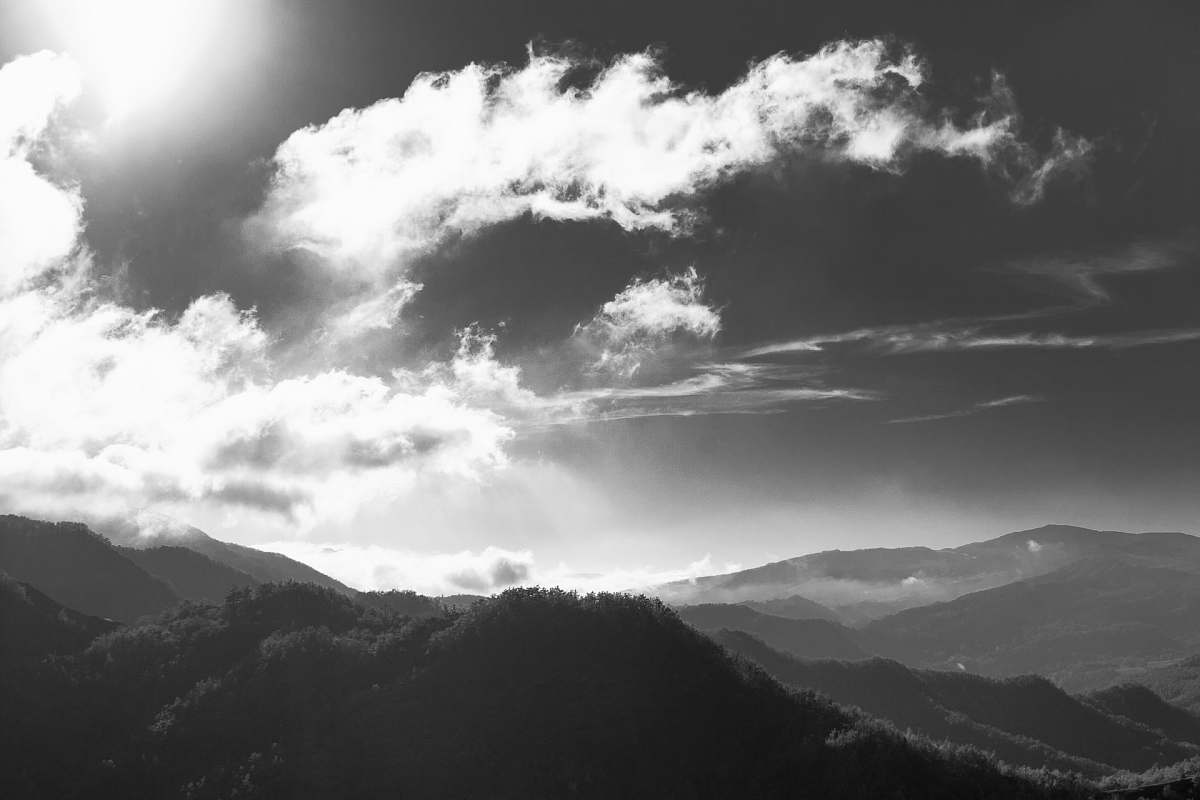 mountains grayscale photography of mountain clouds