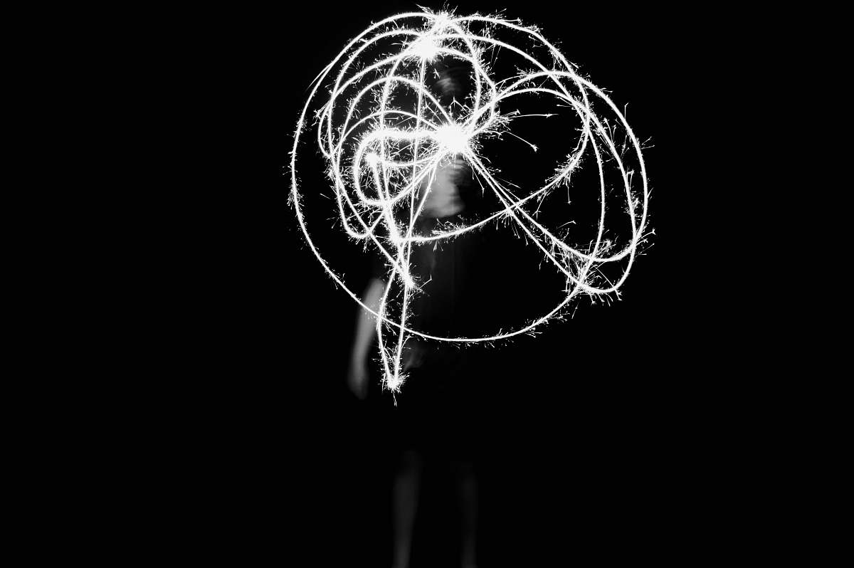 smoke grayscale photography of person playing with light light
