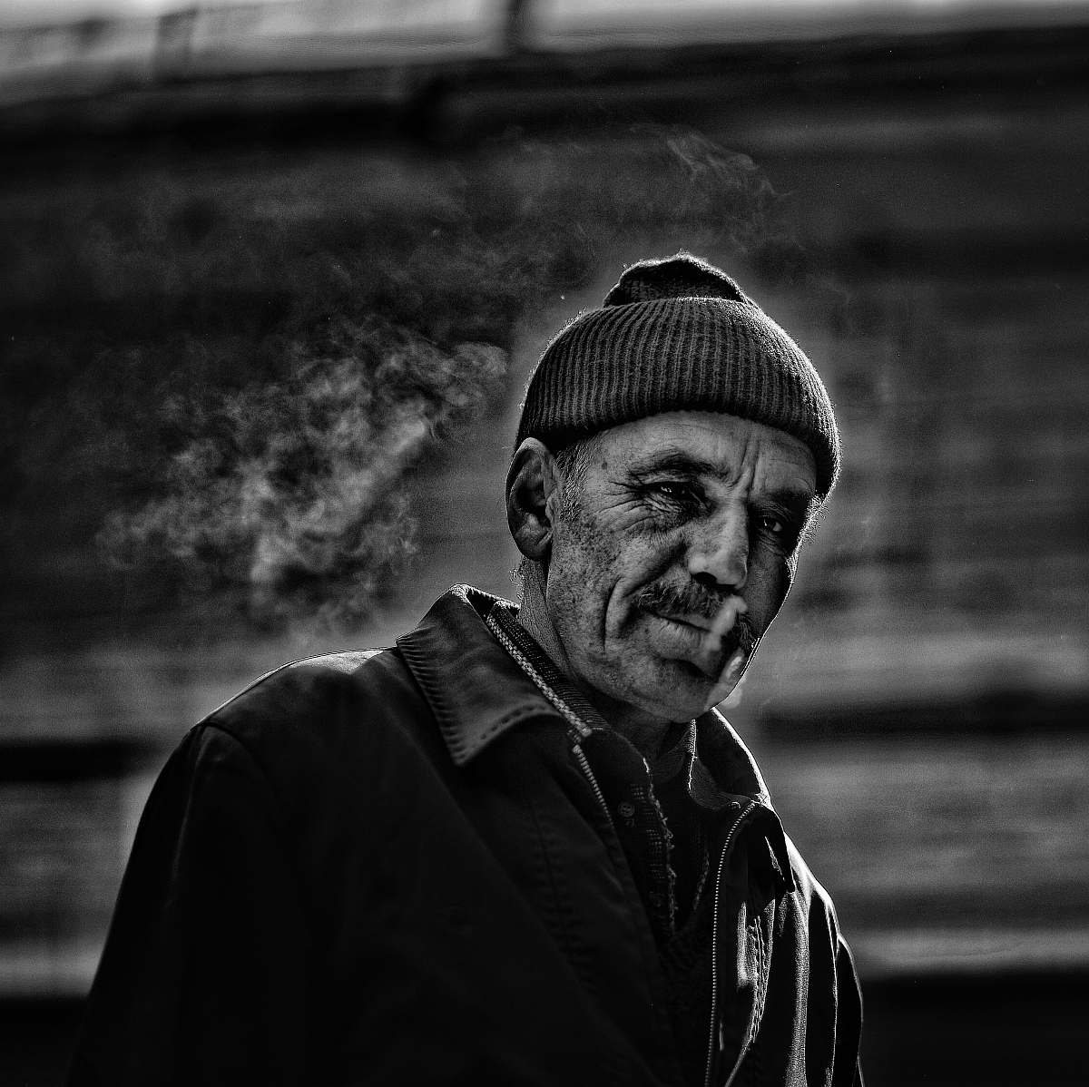 human grayscale photography of smoking man person