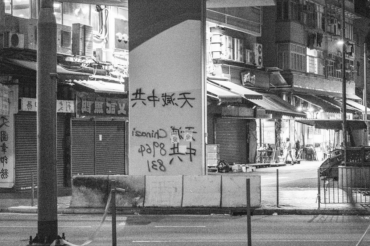 human grayscale photography of texts on wall person