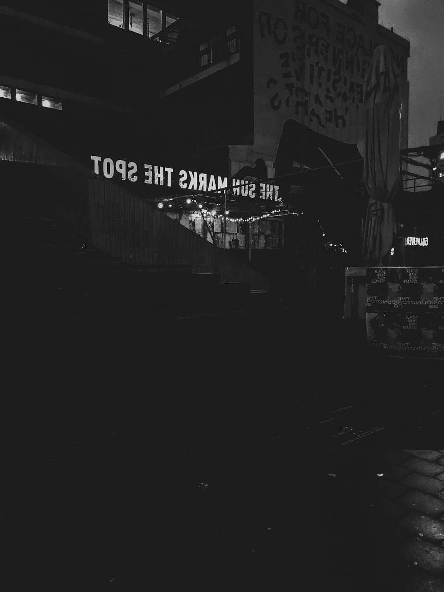 schiestraat grayscale photography of the sun marks the spot printed building netherlands
