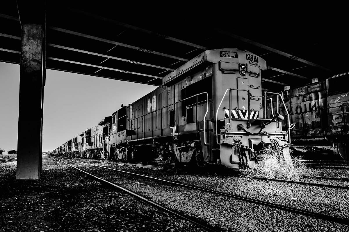 railway grayscale photography of train on station rail