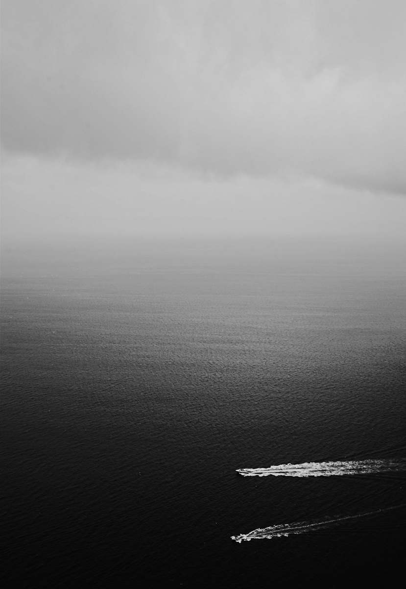 grey grayscale photography of two boats on a body of water majorca