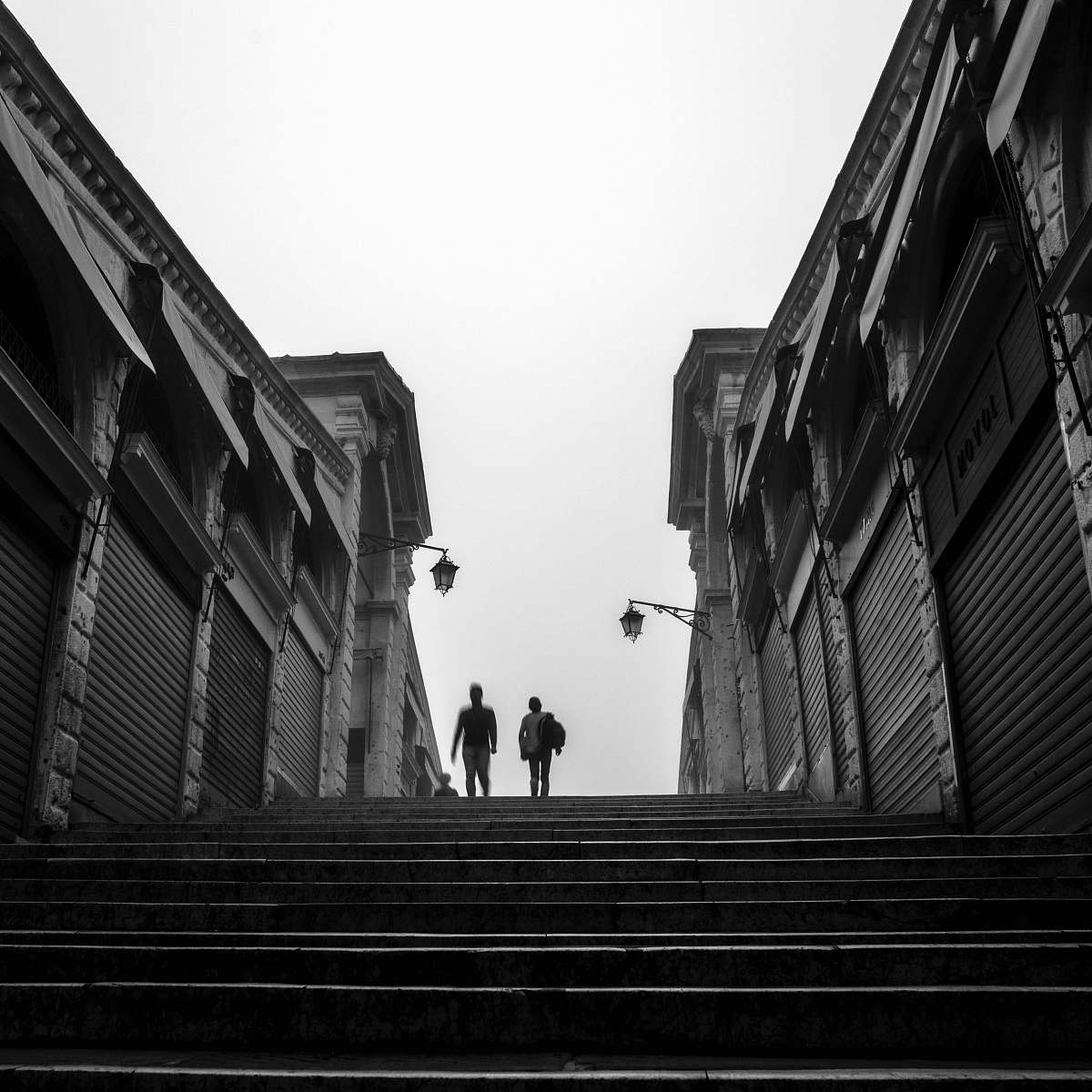 human grayscale photography of two person walking person