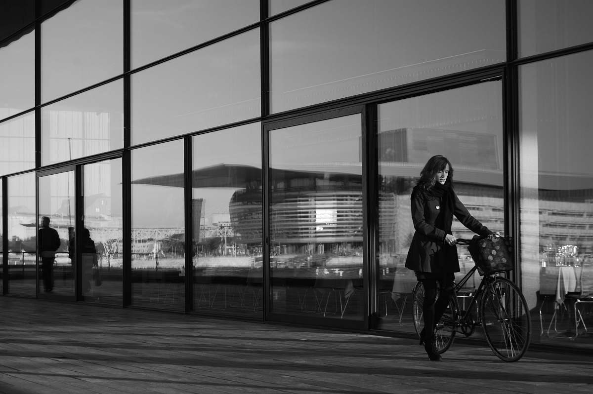 bicycle grayscale photography of woman holding bicycle person