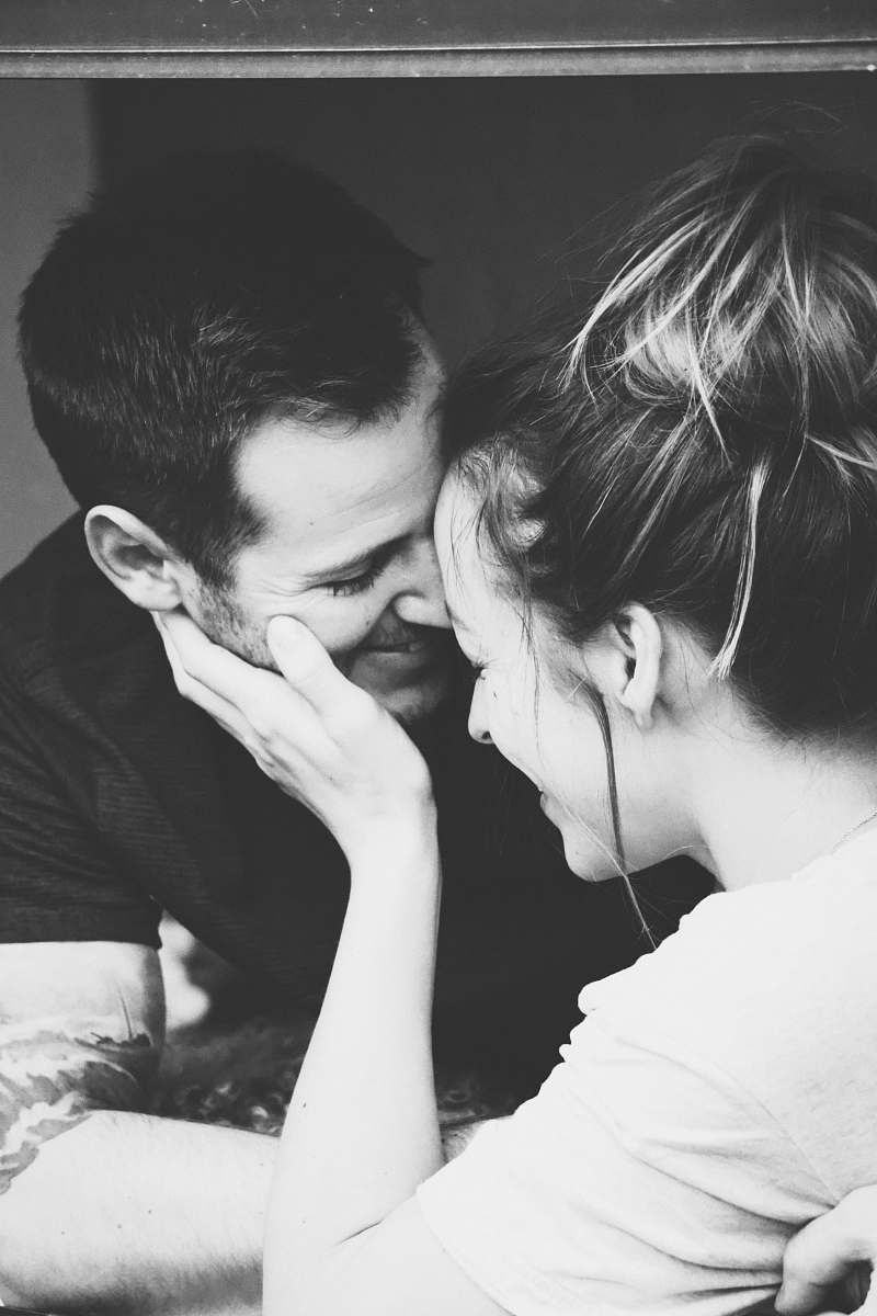 grey grayscale photography of woman holding man's face person