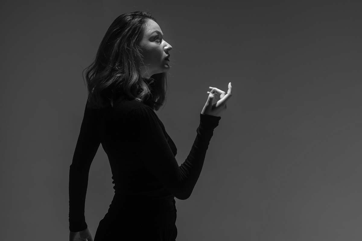 human grayscale photography of woman wearing long-sleeved fitted top person