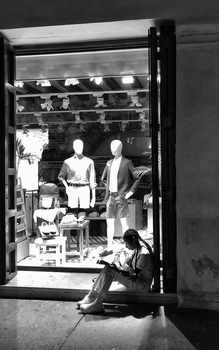 human grayscale photography unknown person sitting indoors person