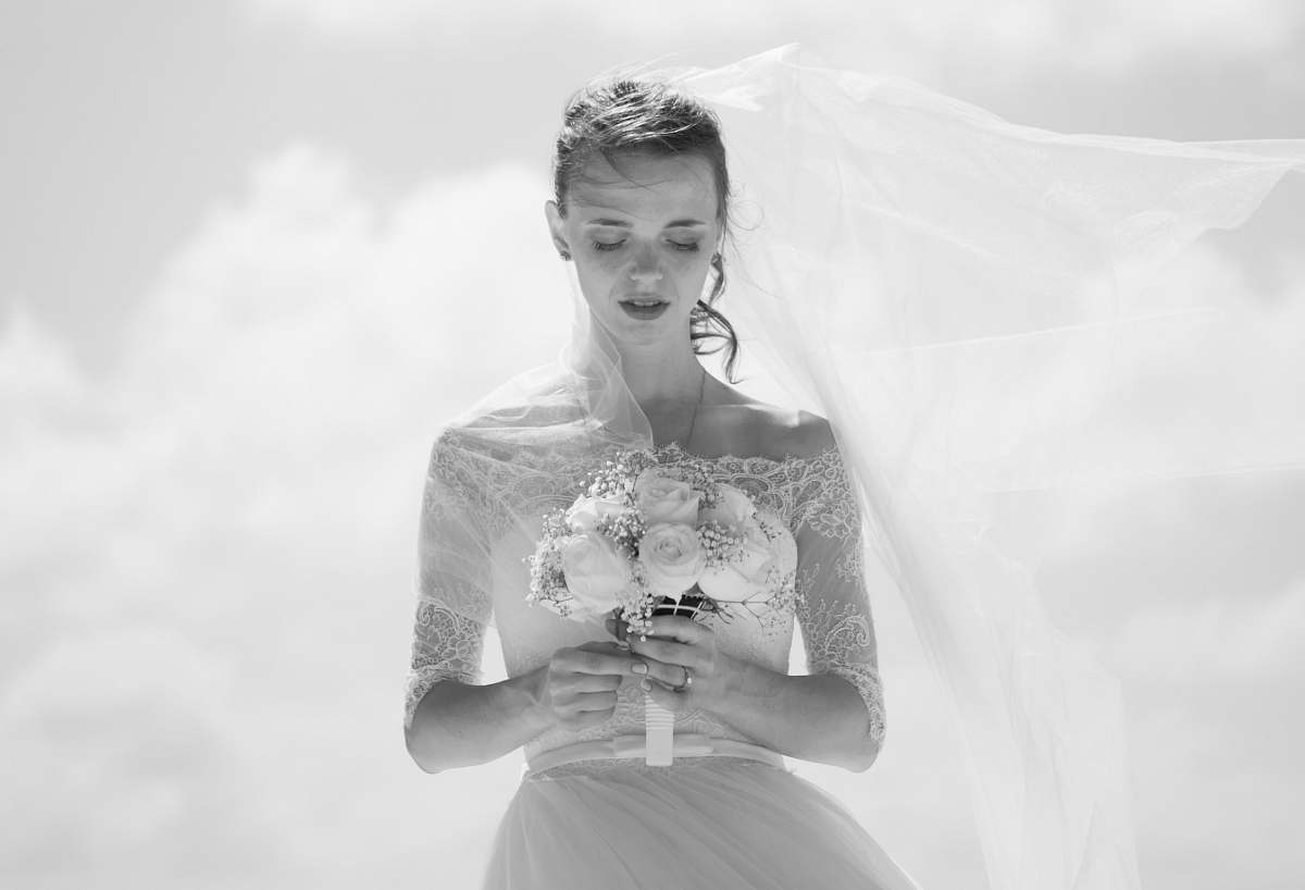 grey grayscale picture of bride holding flower bouquet wedding