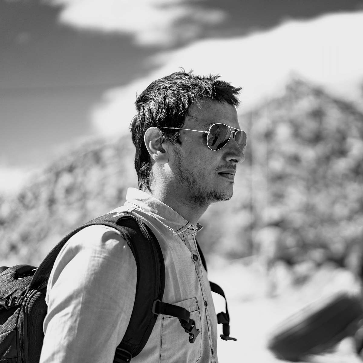 human greyscale photo of man wearing sunglasses person