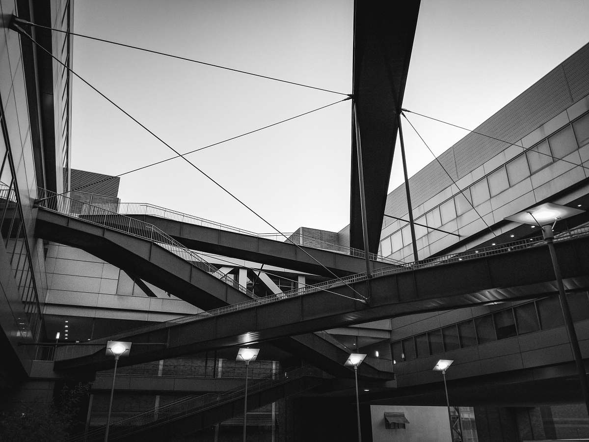 building greyscale photo of metal structure architecture