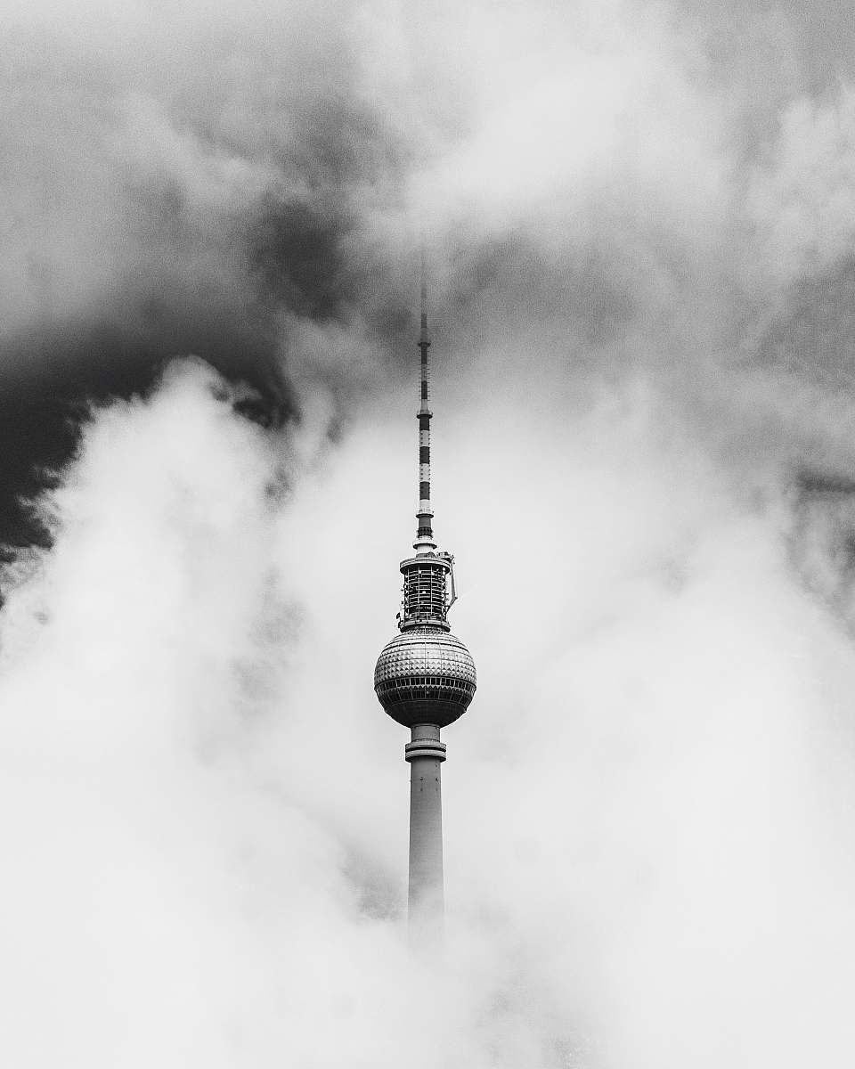 architecture greyscale photo of tower covered in smoke berlin