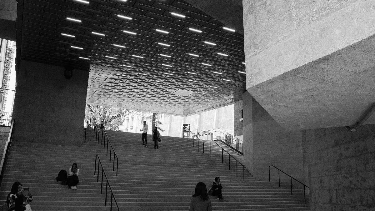 banister group of people standing and sitting on the stairs handrail
