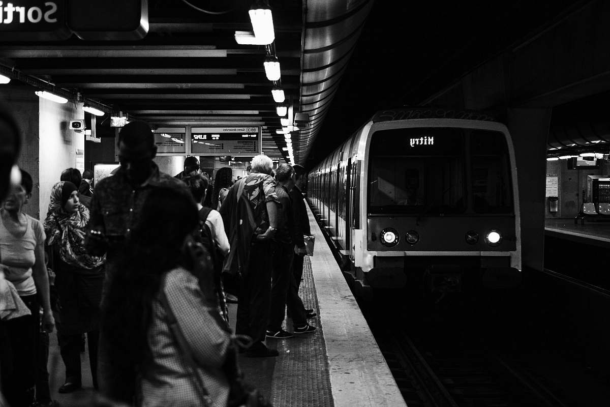 people group of people waiting for the train in grayscale photography subway