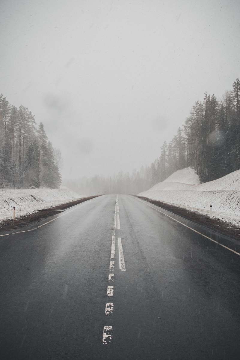 grey highway between snow nature