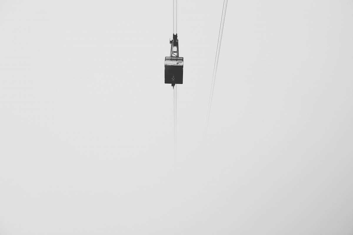 grey low-angle photography of cable car under gray skies zugspitze