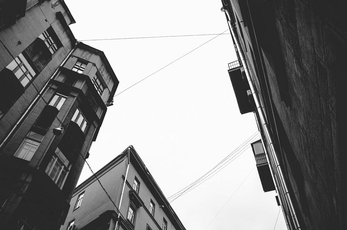 white low-angle photography of grayscale buildings urban
