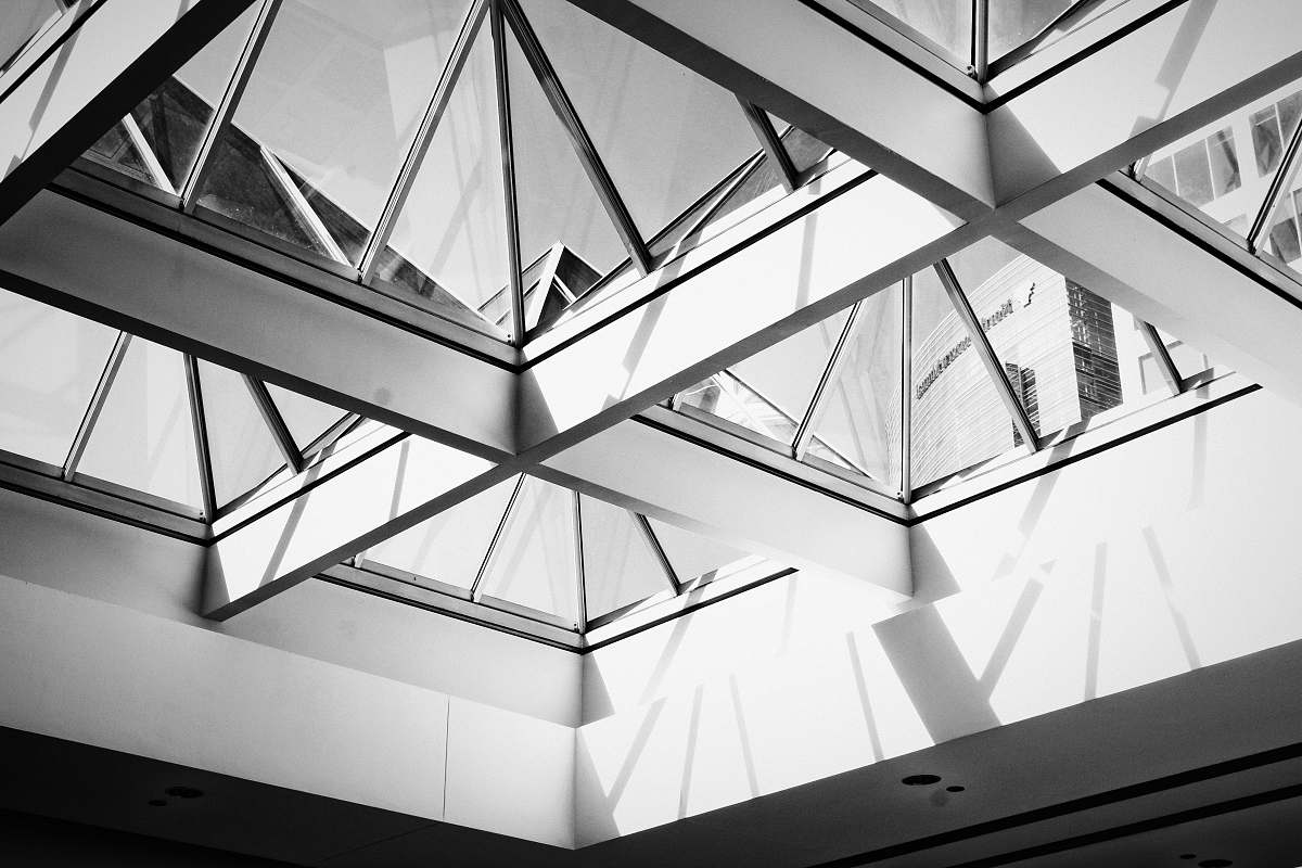 architecture low angle photography of white framed glass roof skylight