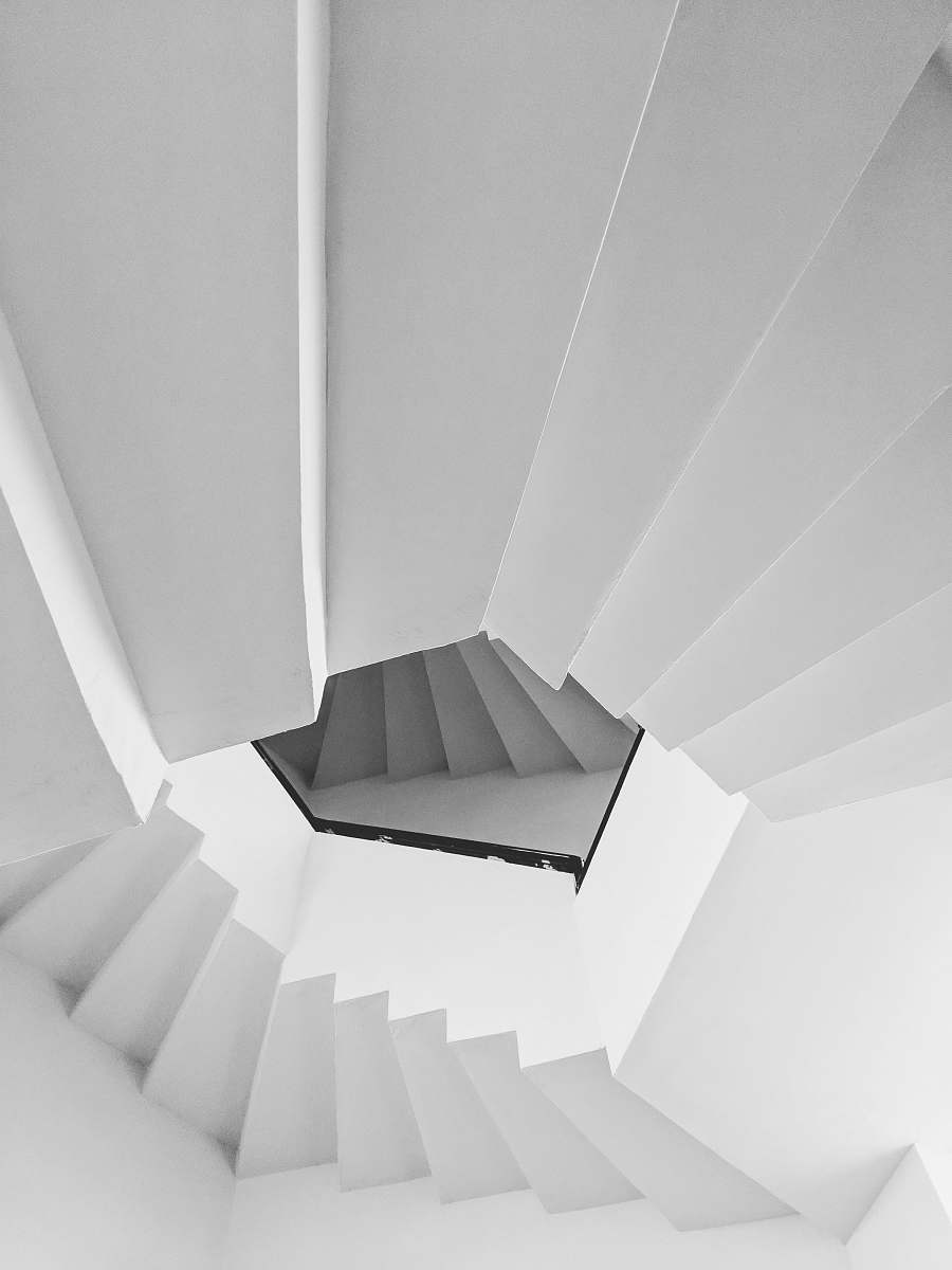 banister low angle view of white spiral stairs handrail