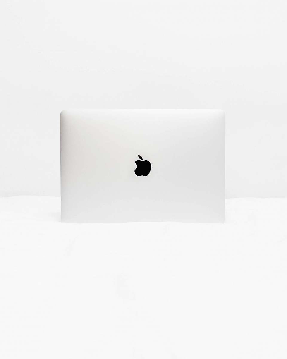 minimal MacBook White open on white surface computer