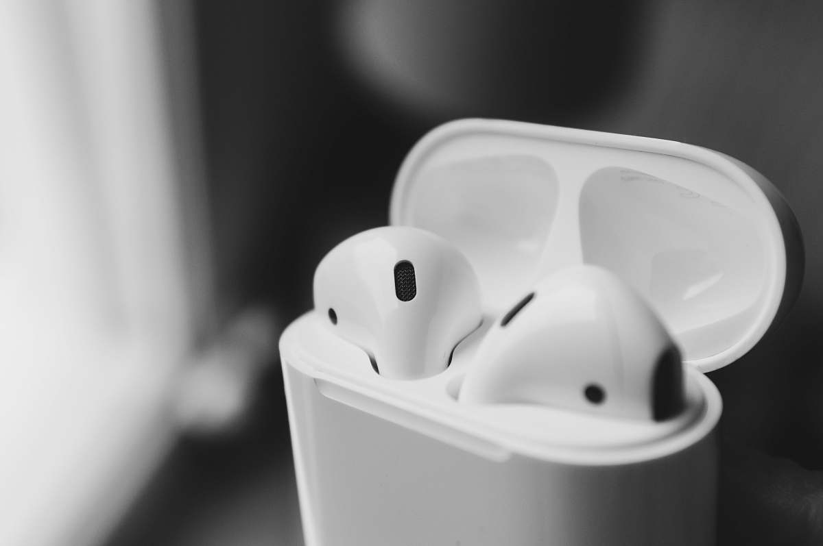 grey macro photography of wireless earbuds in charging case rennes