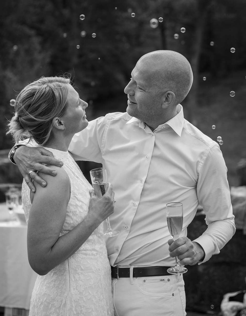 apparel man and woman holding champagne glasses clothing