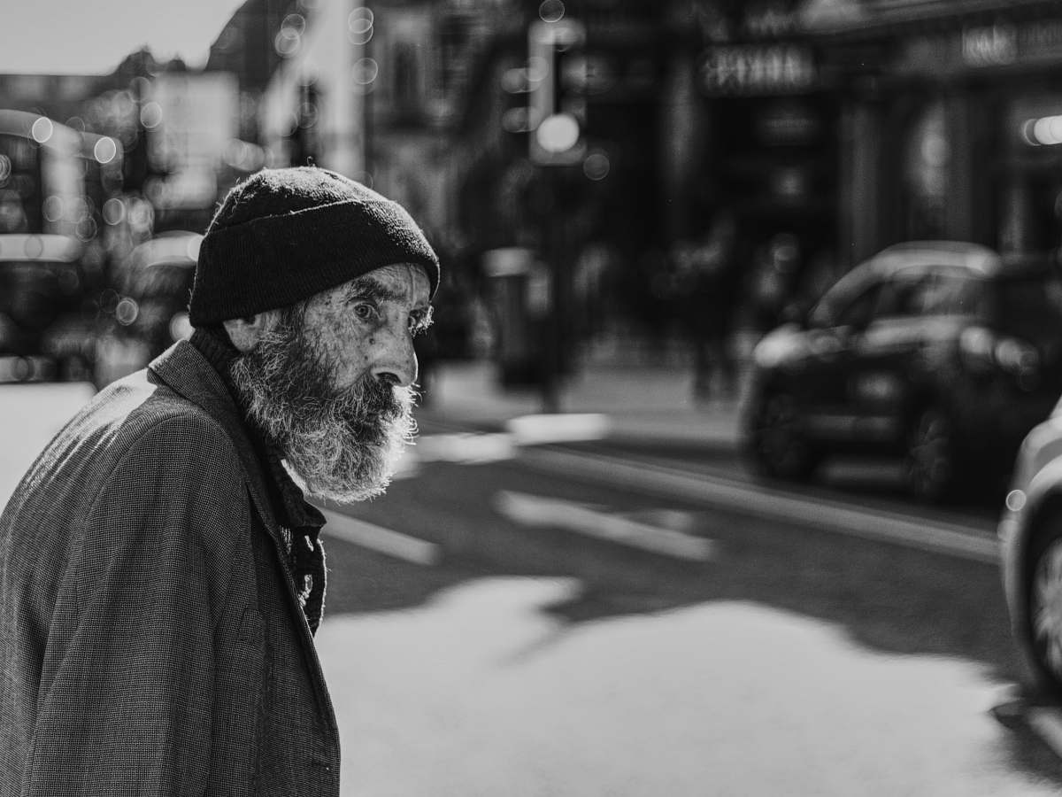 person man beside the road with cars face