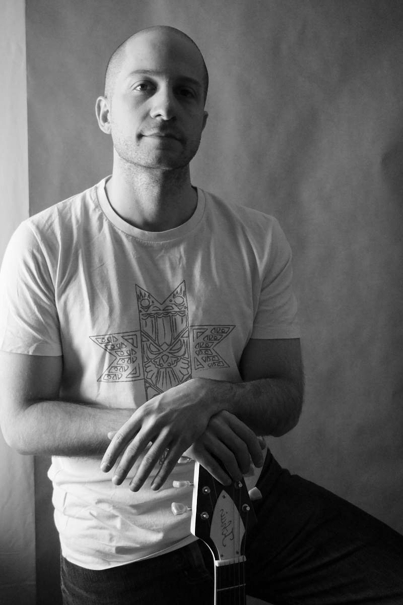 human man leaning on guitar clothing