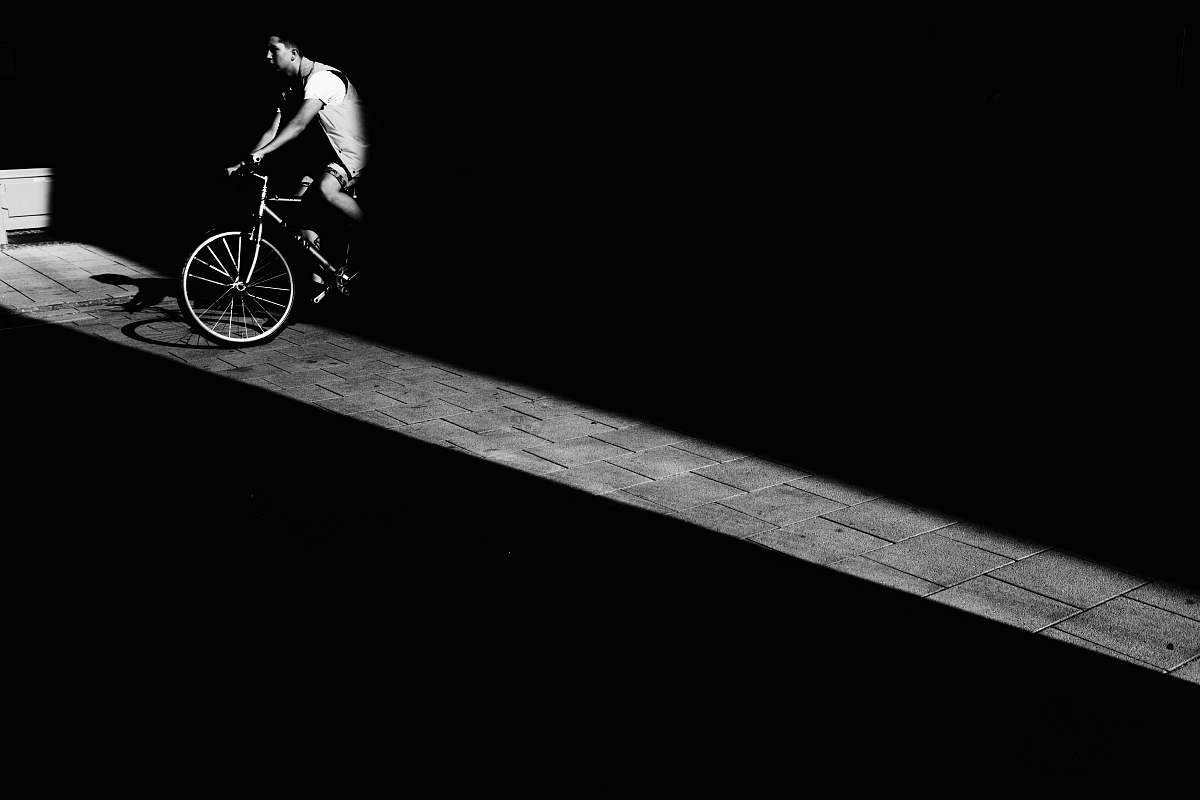 human man riding bicycle in dark area bicycle