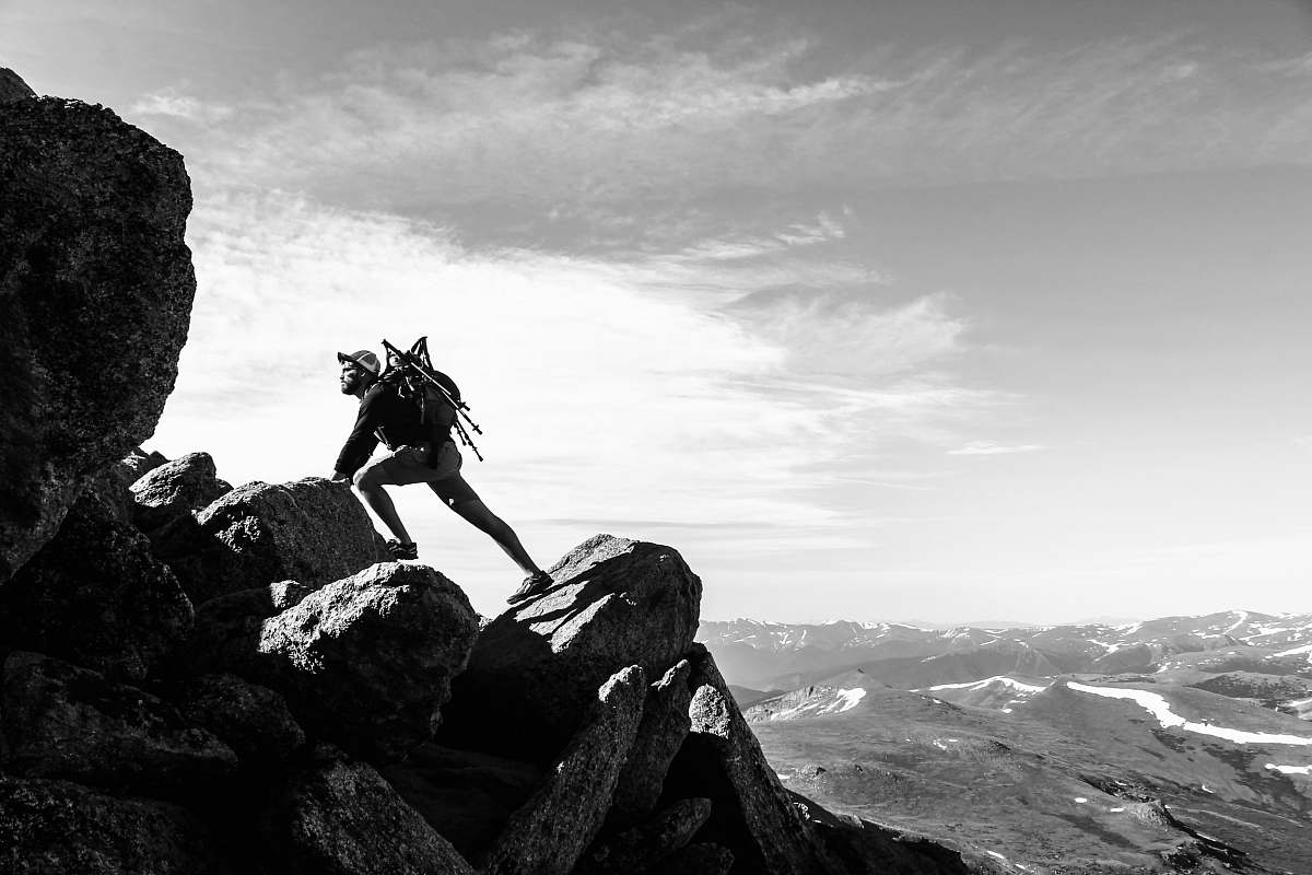 mountain man rock climbing on mountain alps
