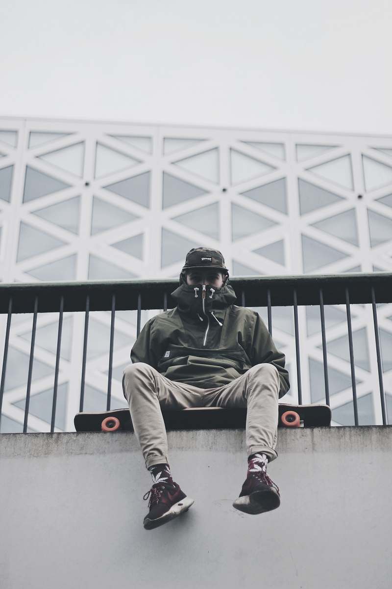 human man sitting longboard person
