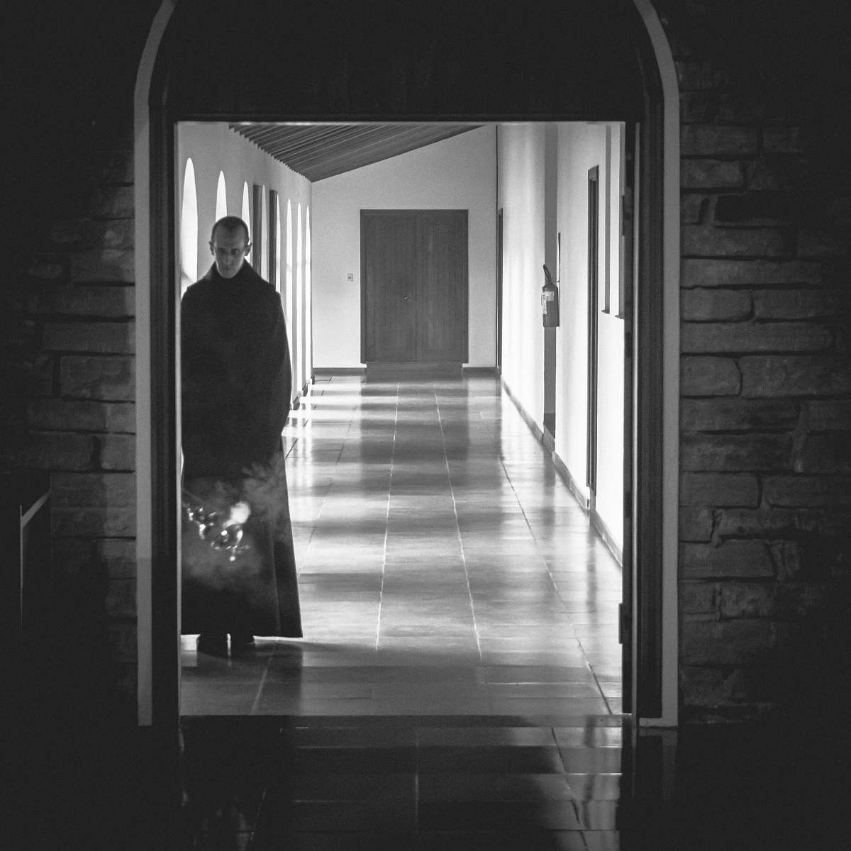 corridor man standing at the side of the open door floor