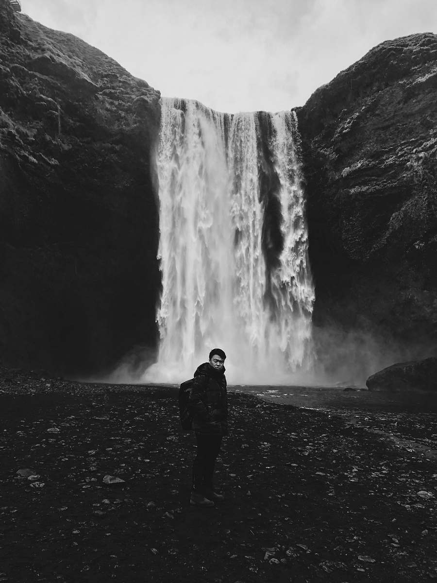 outdoors man standing in front of waterfalls nature