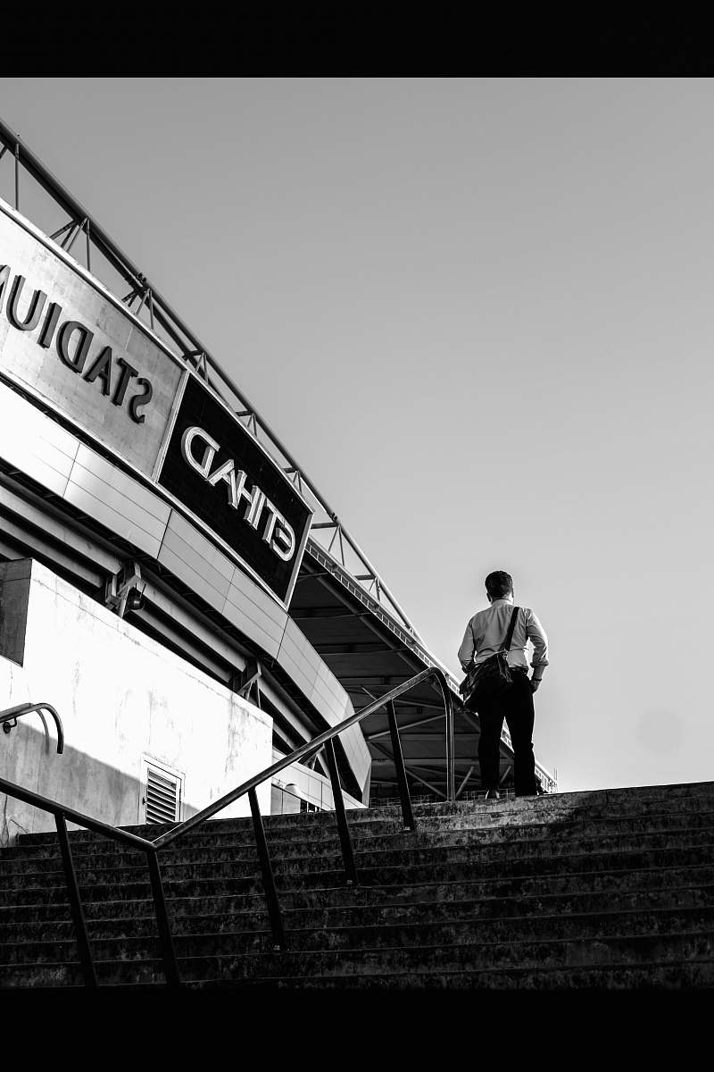 person man standing on the top of the stairs human